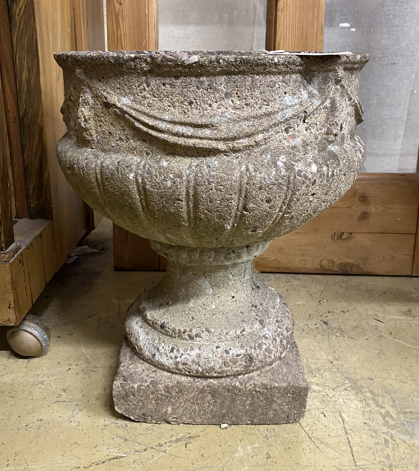 A circular reconstituted stone garden planter with swagged body, diameter 35cm, height 43cm